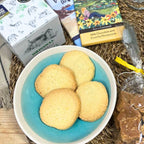 Biscuits in a bowl with chocolate bars and other items on a textured surface