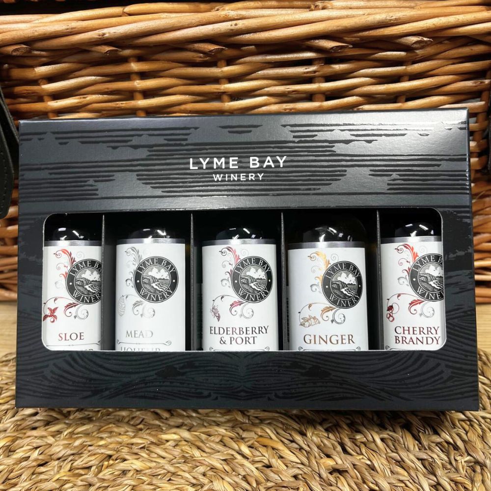 Set of Lyme Bay Winery mini bottles in a gift box on a woven surface