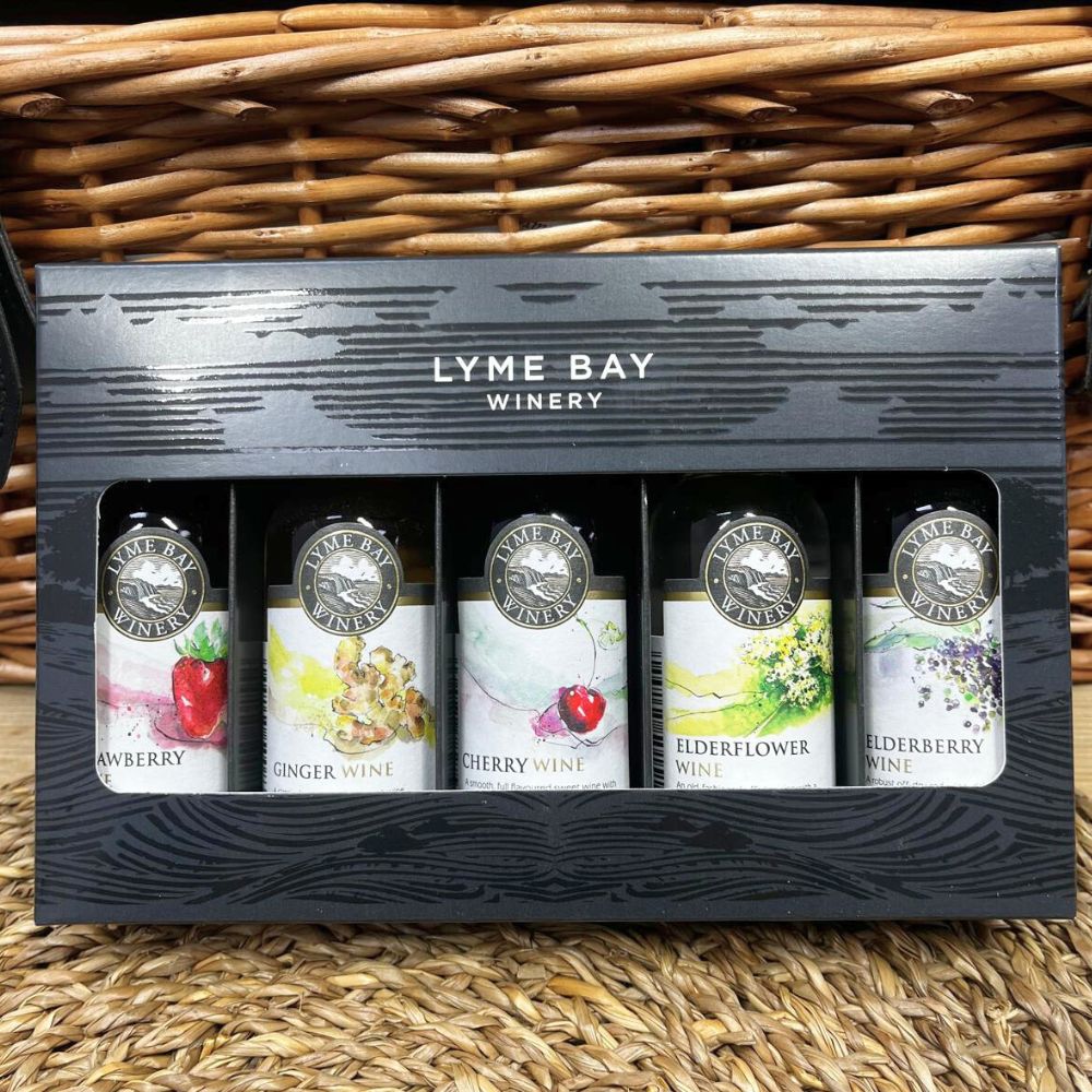 Five bottles of Lyme Bay Winery wine in a gift box on a woven basket background
